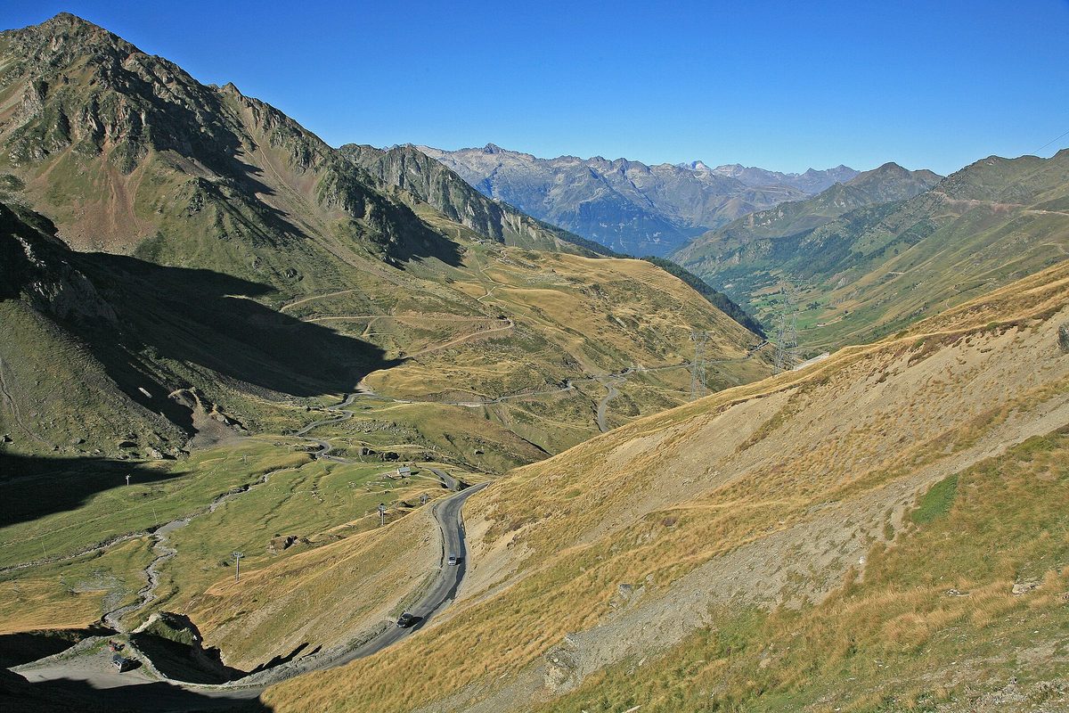 The D918 road winding up through grassy slopes to the Col du Tourmalet in the Pyrenees